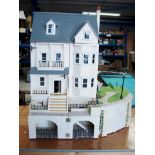 A four storey Dolls House comprehensively furnished to every room, illuminated and very detailed