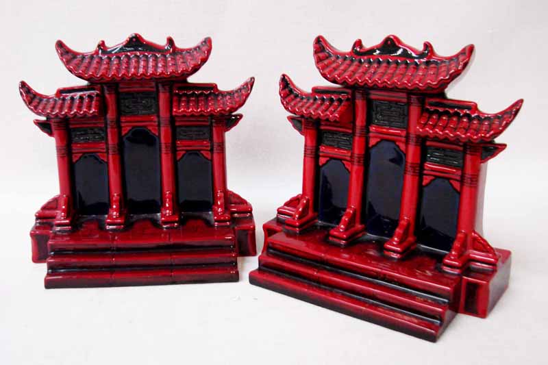A pair of Royal Doulton flambe Book Ends in the Pilou Gate design numbers BA76 and BA77 modelled