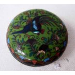 A Japanese cloisonne Lidded Box of circular form decorated with a pheasant amongst foliage on jade