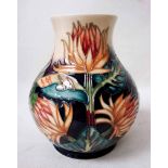 A Moorcroft Pottery Baluster Vase, tubeline decorated in the Burdock design by Philip Gibson,