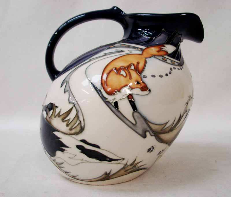 A Moorcroft pottery Jug/Ewer of stylised angled form decorated by Kevin Goodwin with fox and badgers