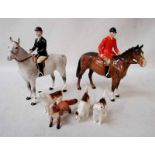 A Beswick pottery hunting group: a Huntsman in red jacket astride brown horse, a Huntswoman
