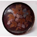 An Arts and Crafts Copper Tray of circular form with toothed rim, inlaid with brass and white