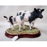 A Border Fine Arts model of a Belgian Blue Cow and Calf by Jack Crewdson, number B0929, limited