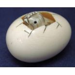 A Japanese carved ivory Netsuke as a Chick emerging from an Egg, chick carved separately and sits