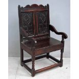 An 18th century jointed oak Wainscott Chair, the shaped top rail flanked by plain uprights,