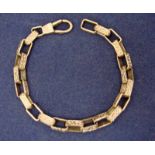 A 9ct gold chain bracelet of box link form, each link scroll decorated, 20cm long, 22.4g