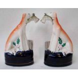 A pair of 19th century Staffordshire pottery Quill Holders modelled as seated Greyhounds with Rabbit