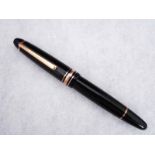 A Mont Blanc Meisterstuck ball Point Pen, black and gilt metal mounted case with screw on cap, white