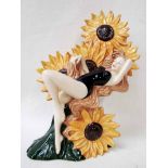 A Carlton ware Sunflower figure as a female in black bathing costume reclining against a