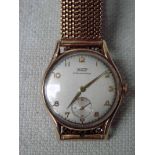 A Tissot 9ct gold cased manual wind Wrist Watch, the silvered 30mm dial with Arabic numerals,