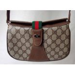 Gucci Accessory Collection, a Flap Bag with shoulder strap, bears leather tab inscribed Gucci