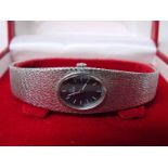 A ladies 9ct white gold Omega Bracelet Watch, dark blue oval face with baton markers, signed Omega