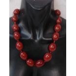 A string of eighteen large graduated Cherry Amber beads