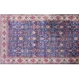 AN ANTIQUE PERSIAN BAKHTIARI CARPET, the midnight blue field containing flower filled bouquets