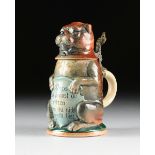 A GERMAN GLAZED CERAMIC AND PEWTER MOUNTED FIGURAL CHARACTER BEER STEIN, CIRCA 1900, modeled as a