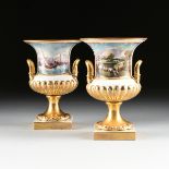 A PAIR OF CONTINENTAL PARCEL GILT PORCELAIN CAMPANA FORM URNS WITH HAND PAINTED DECORATION AFTER