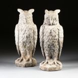 A LARGE PAIR OF CAST STONE GARDEN OWLS, 20TH CENTURY, each modeled in relief as a horned owl