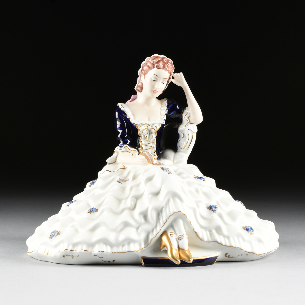 A ROYAL DUX (DUCHCOVSKY) PORCELAIN HAND PAINTED FIGURE OF A SEATED WOMAN, DUCHOV, CZECHOSLOVAKIA,