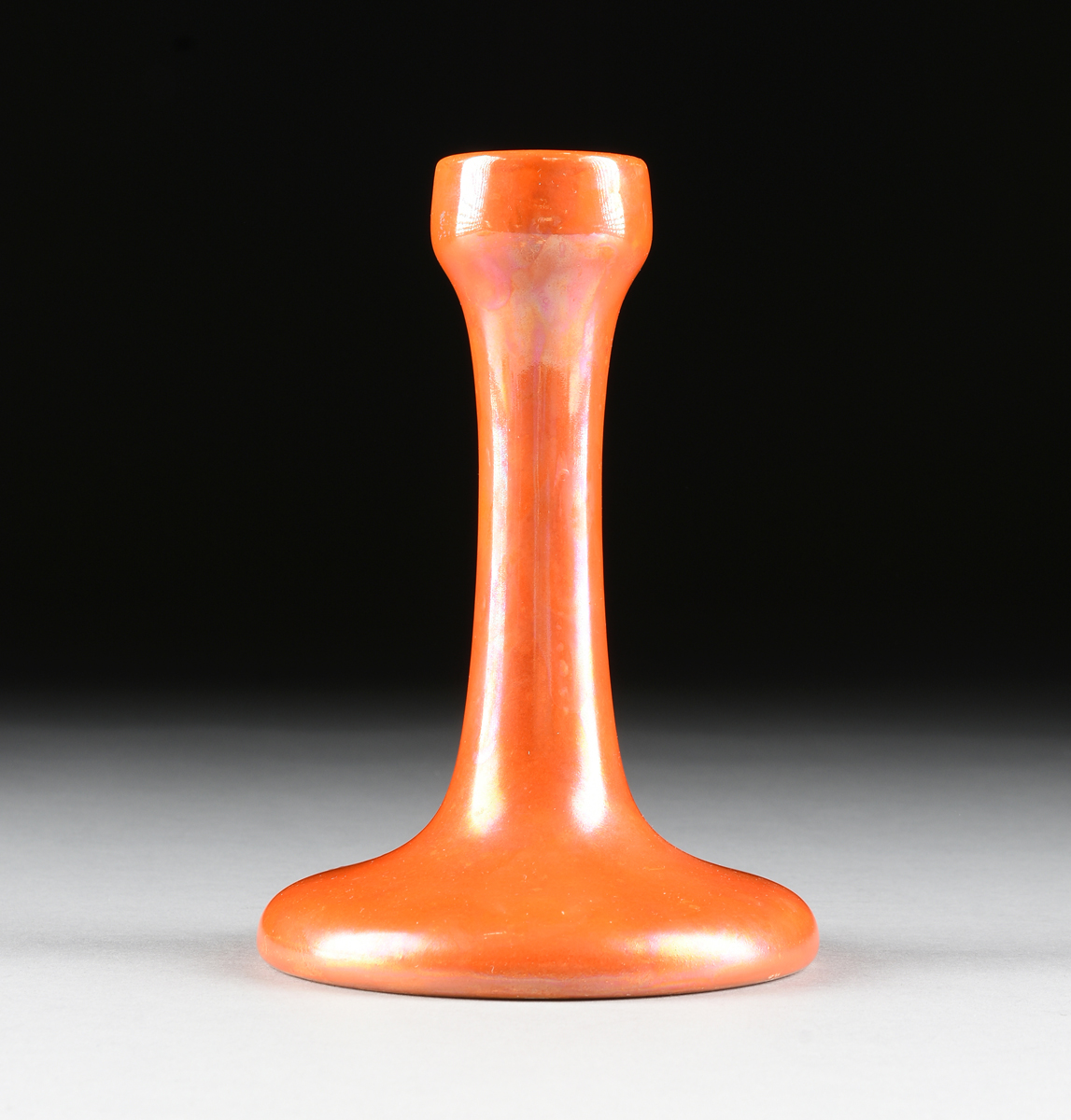 A RUSKIN POTTERY ORANGE LUSTER GLAZED CANDLESTICK, BIRMINGHAM, ENGLAND, 1922, the molded candlestick