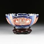 A JAPANESE IMARI PORCELAIN FLUTED CENTER BOWL, LATE 19TH CENTURY, the traditional Imari palate