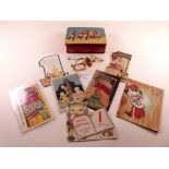 A group of antique 1st Birthday cards and postcards and a Sharps toffee tin