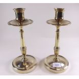 A pair of brass candlesticks with drip trays - 27cm
