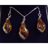 A silver amber necklace and pair of earrings
