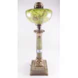 A Victorian gilt metal and onyx oil lamp with green glass reservoir