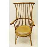 An antique lightwood stick back farmhouse chair