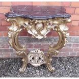 A good carved gilt continental console table with elaborate scrollwork base and marble top