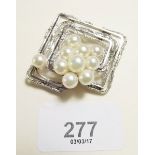 A silver and pearl modernist brooch