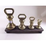 A set of four Victorian/Edwardian brass bell weights 1lb, 2lb, 4lb and 7lb