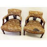 A pair of Victorian tub chairs with carved and upholstered backs