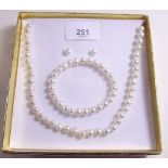 A silver pearl, earrings, bracelet and necklace set