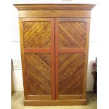 A Victorian pitch pine two door wardrobe enclosing hanging space, linen trays and drawers, 54" x 21"