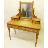 A Victorian pine dressing table with mirror over two drawers raised on slender supports