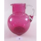 A Victorian crackled cranberry glass jug - 19cm