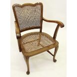 A 1930's cane back and seat small open armchair