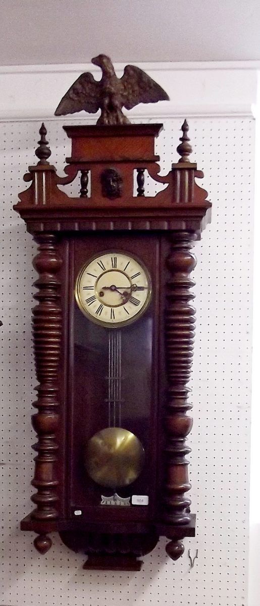 A large Vienna style walnut wall clock with eagle surmount