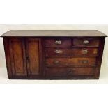 An early 19th century pine side cabinet with cupboard and drawers with military style brass handles,