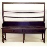 An 18th century oak Welsh dresser of wide proportions with two tier back over two drawers, all