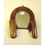 A vintage horseshoe form clothes brush and mirror set