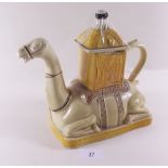 A novelty teapot in shape of camel with rider by Tony Wood of Stoke on Trent