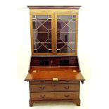 A Georgian mahogany bureau bookcase with a pair of astragal glazed doors over slope front