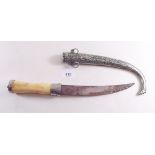 An Eastern dagger with white metal sheath and bone handle