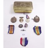 A WWI 1914 Christmas Chocolate box and various military related badges including RAF cap badges,
