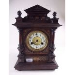 A Victorian carved mantel clock with transfer decoration - hinge to glass face a/f