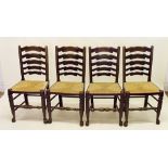 A set of four rush seated ladder back dining chairs