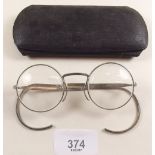 A pair of RAF issued spectacles in case with instructions that they can be worn with a respirator